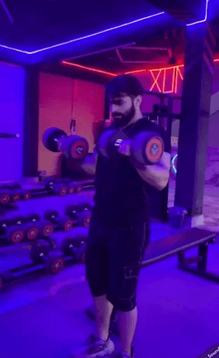 Member doing dumbbell curls
