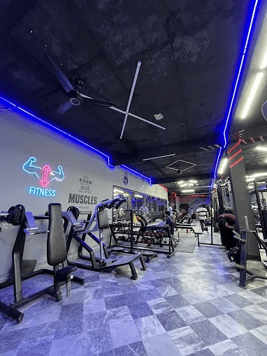 Mux Fitness gym floor with blue neon lighting and strength machines